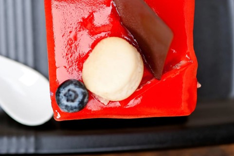 Fresh strawberry yogurt mousse with macaroon and blueberry on top