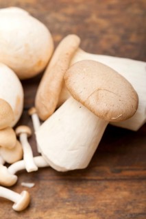 Bunch of fresh wild mushrooms on a rustic wood table