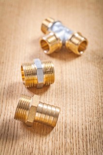 Three sanitary fittings on wooden panel