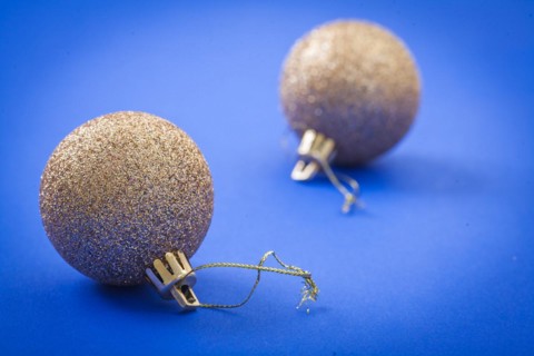 Golden Christmas baubles on a blue background