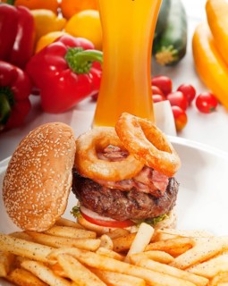 Classic american hamburger sandwich with onion rings and french fries