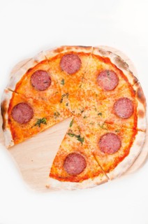 Italian original thin crust pepperoni pizza isolated on white