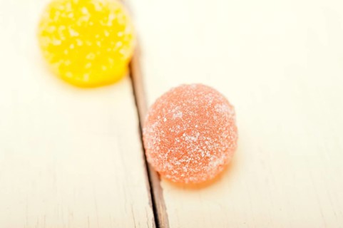 Sugar jelly fruit candy over white wood table