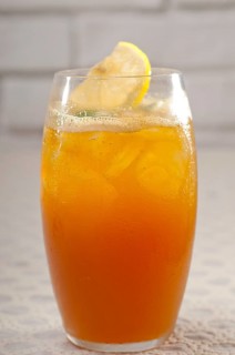 Refreshing Ice tea closeup macro with lemon and mint leaves