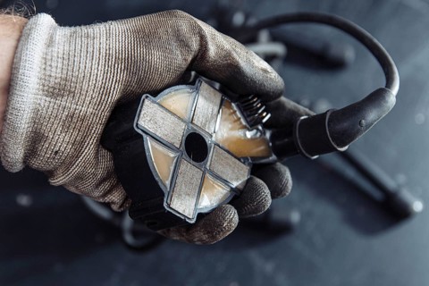 Engine ignition coil in hand of auto mechanic