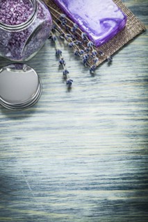 Handmade soap lavender aromatic crystal sea salt jar cover on wooden board spa treatment concept