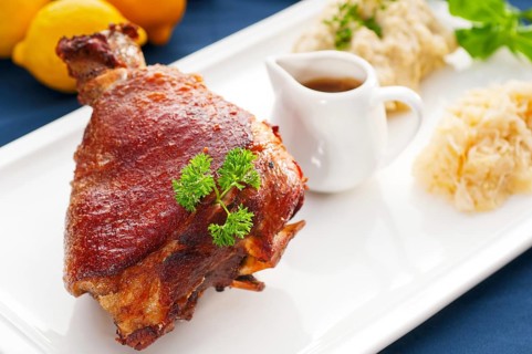 Original German BBQ pork knuckle served with mashed potatoes and sauerkraut