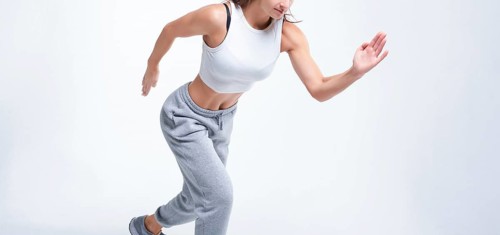 No name portrait. Sports woman runner on a white background. Photo of an attractive woman in fashionable sportswear. Dynamic movement. Side view. Sports and healthy lifestyle. Mixed media