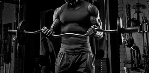 No name strong athletic man pumping up muscles