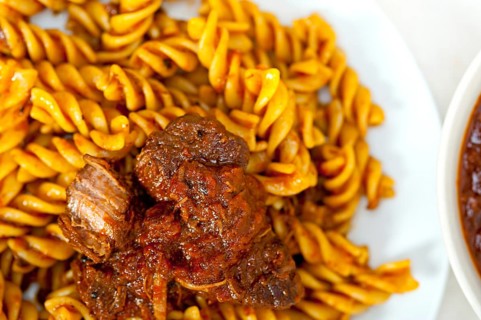 Fusilli pasta al dente with neapolitan style ragu meat sauce very different from bolognese style