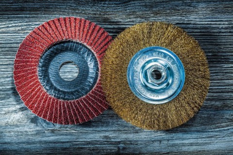 Abrasive disc wire brush on vintage wooden board