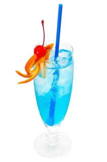 Blue long drink cocktail with orange and cherry garnish and blue straw