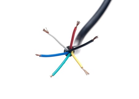 Color coded electric wire over white background