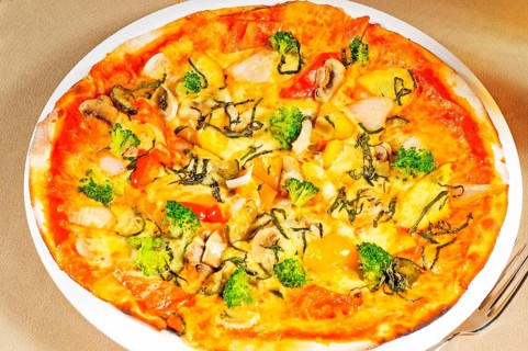 Fresh italian thin style vegetarian pizza with fresh mixed vegetables close up