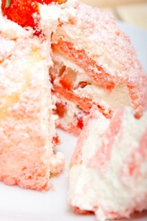 Fresh pink strawberry and whipped cream dessert macro close up