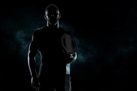 Kickboxer with a belt on his shoulder poses against a background of smoke. Sports competitions. Fight night. The concept of mixed martial arts. MMA
