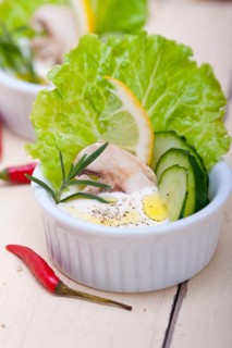 Fresh organic garlic cheese dip salad on a rustic table