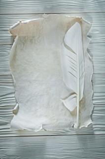 Quill vintage paper sheet on wooden board