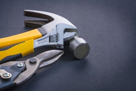Adjustable spanner Claw hammer Steel cutter on black background