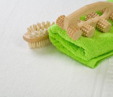 Brush and massager with green towel