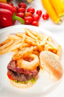Classic american hamburger sandwich with onion rings and french fries