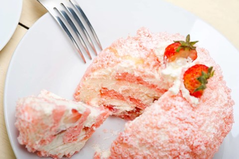 Fresh pink strawberry and whipped cream dessert macro close up