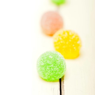 Sugar jelly fruit candy over white wood table