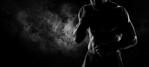 Noname image of a kickboxer on a dark background. The concept of mixed martial arts. MMA