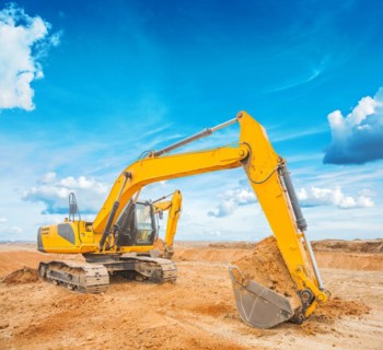 Excavator on construction site and sky background