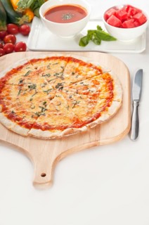 Italian original thin crust pizza Margherita with gazpacho soup and watermelon on side