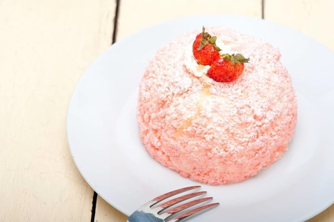 Fresh pink strawberry and whipped cream dessert macro close up