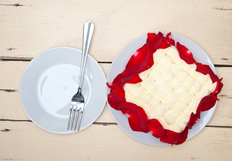Whipped cream mango cake with red rose petals