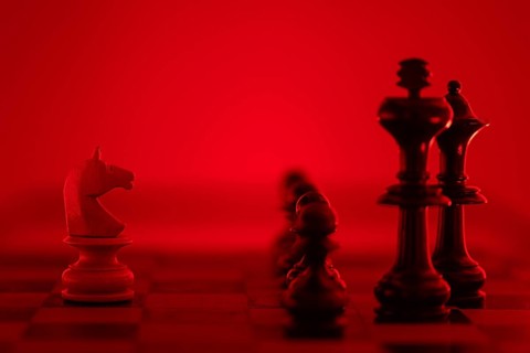 Chess pieces illuminated in a red light