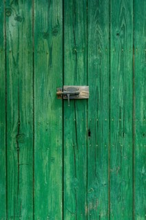 Old wooden door with aged metal door handle. Architectural textured background