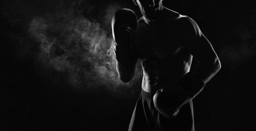 Noname image of a kickboxer on a dark background. The concept of mixed martial arts. MMA