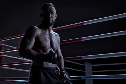 Kickboxer showing thumbs up standing near the ring. Sports competitions. Fight night. The concept of mixed martial arts. MMA