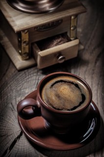 Brown coffee cup and mill close up view