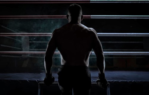 Kickboxer climbs into the ring. View from the back. Sports competitions. Fight night. The concept of mixed martial arts. MMA