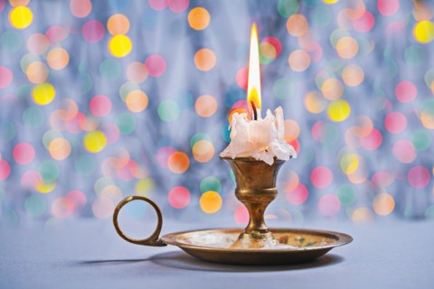 Gloving candle in vintage candlestick on background of bokeh
