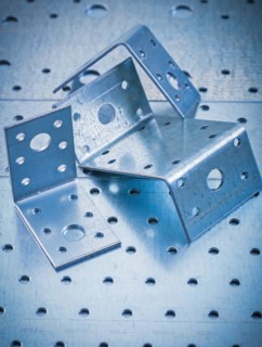 Stainless drilled angle fasteners on perforated sheet metal construction concept