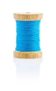 A small wooden spool with blue thread