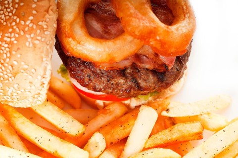 Classic american hamburger sandwich with onion rings and french fries