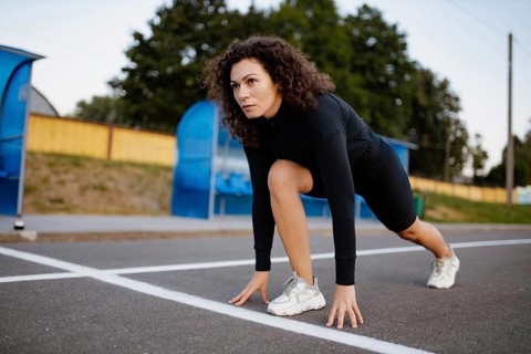 Curly girl runner is engaged in athletics
