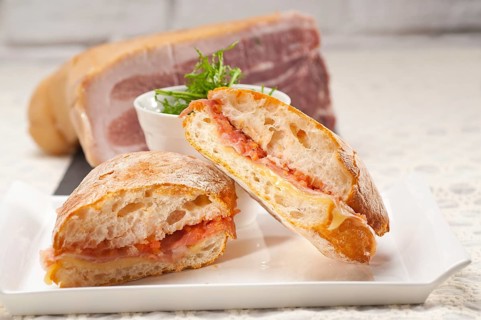 Italian ciabatta panini sandwich with parma ham and tomato