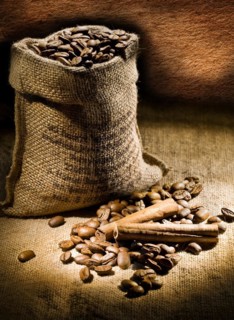 Dark composition of coffee beans and linen bag