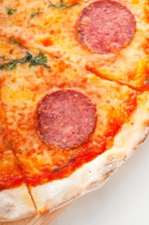 Italian original thin crust pepperoni pizza extrene close up