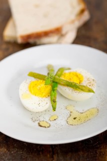 Boiled fresh green asparagus and eggs with extra virgin olive oil with rustic bread