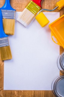 Aerial view copyspace image painting tools on white sheet of paper with space for your text