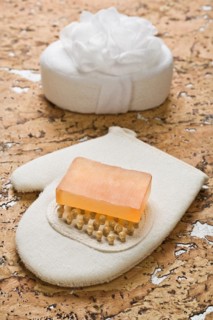 Bath sponge and soap on cork wood