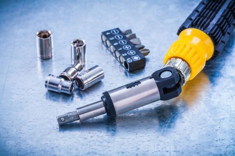 Horizontal image of reversible screw Screwdriver bits and Torx on metallic background Construction concept